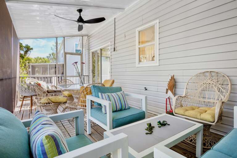 Screened lanai with outdoor dining and lounge seating