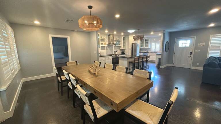 Gather around this stunning dining table where memorable meals and conversations await your group in this beautiful open-concept space.