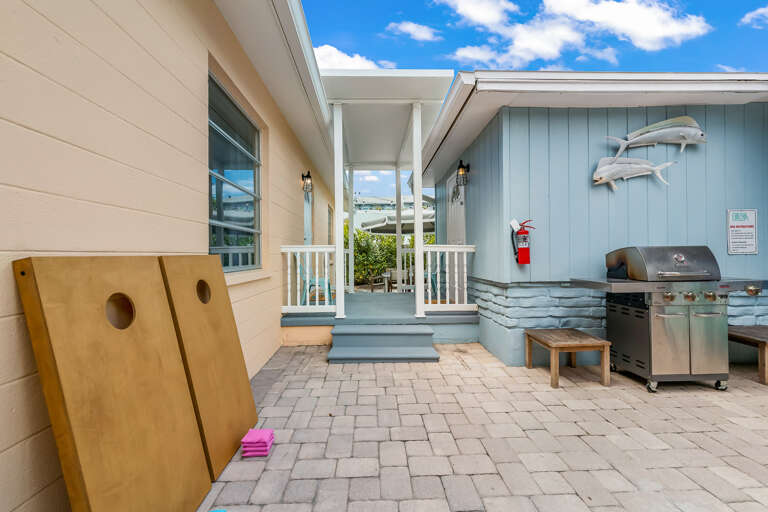 BBQ grill, beach chairs and two cornhole games