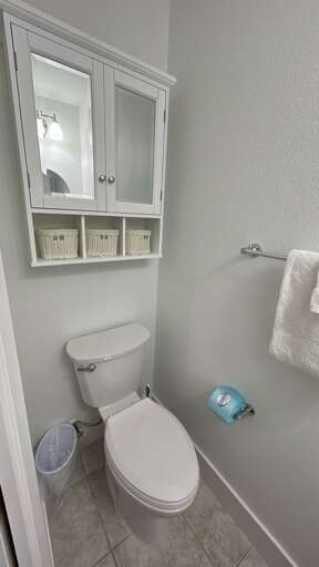 Your private bathroom features thoughtful storage with wicker baskets and a clean, comfortable design.