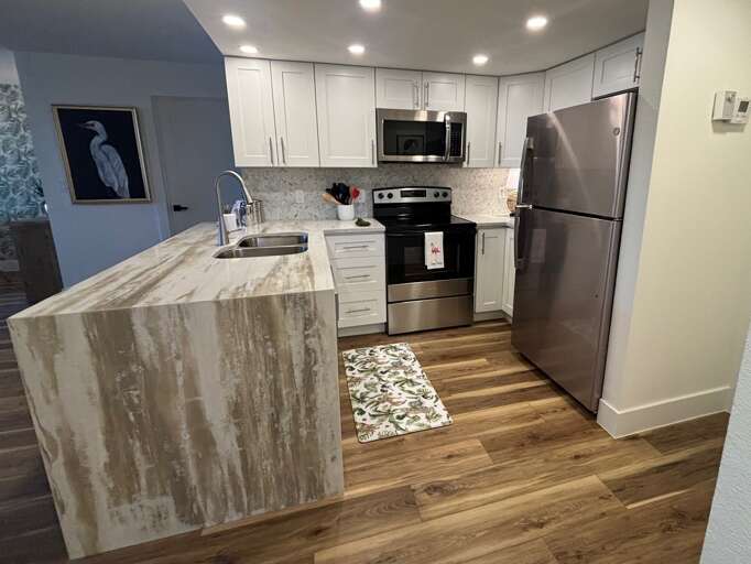 Your fully equipped kitchen features stainless steel appliances, marble countertops, and everything you need to create memorable meals during your stay.