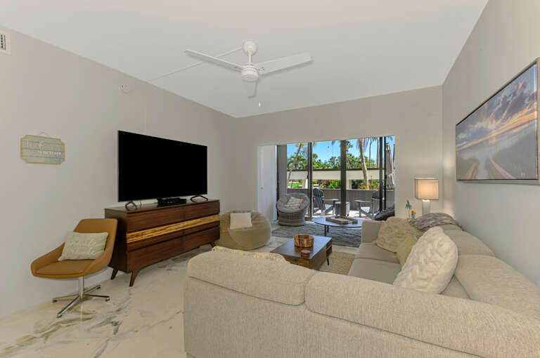 Sink into plush seating while enjoying your favorite shows on the large TV, with tropical views beckoning from your private balcony.