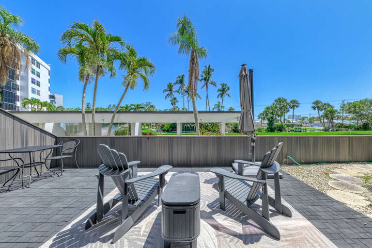 Soak up Florida sunshine on your private patio, where Adirondack chairs and tropical palm views create the perfect outdoor retreat.