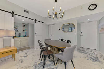 Stylish dining space with modern chandelier where you'll enjoy meals around the elegant table.