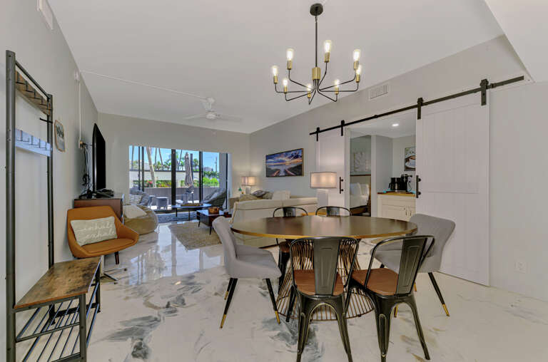 Unwind in your stylish open-plan living space with modern furnishings, elegant lighting, and sleek marble floors creating the perfect atmosphere for relaxation.
