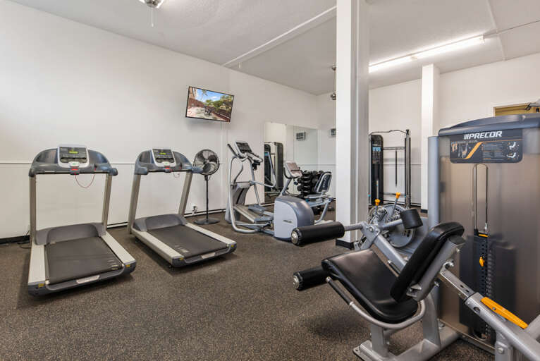 Stay active during your getaway in this well-equipped fitness center featuring treadmills, ellipticals, and strength training equipment for your daily workout routine.