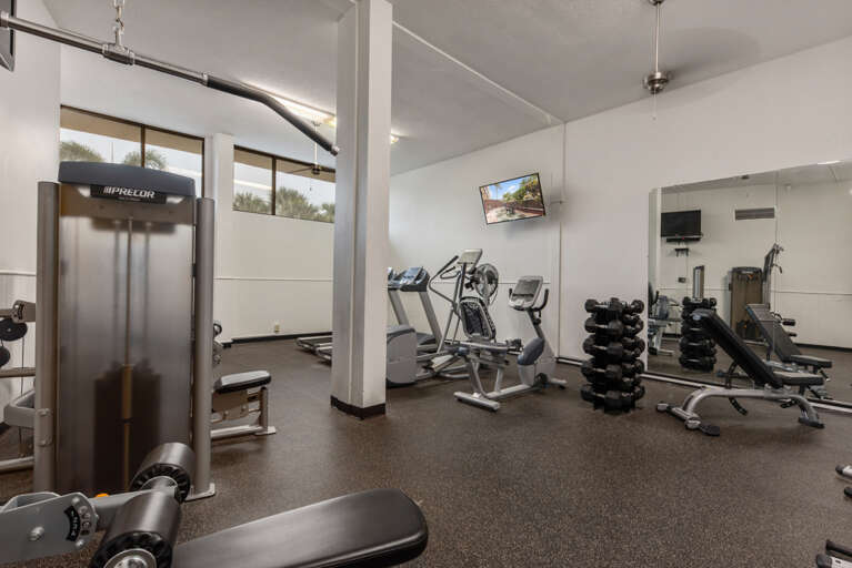 Your fitness goals await in this well-equipped gym, complete with modern cardio machines, free weights, and strength training equipment for your daily workout.