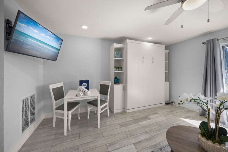 Your modern studio features a Murphy bed, dining nook, and wall-mounted TV for comfortable relaxing after exploring.