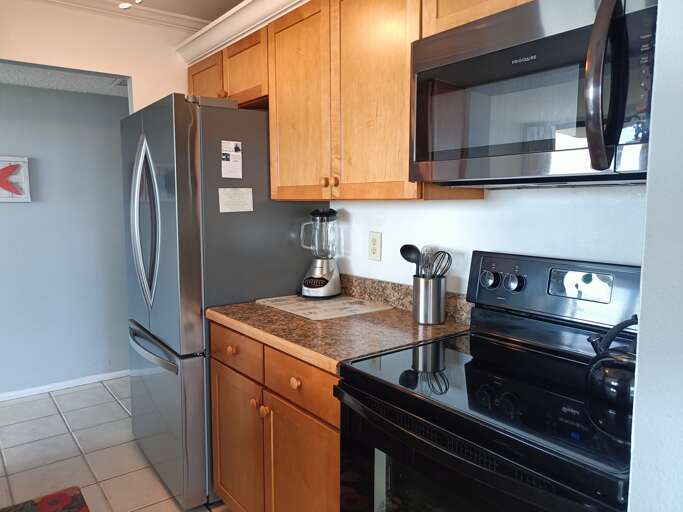Your fully equipped kitchen features stainless steel appliances, granite countertops, and warm wood cabinetry for all your culinary adventures.