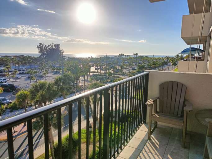 Unwind on your private balcony with a refreshing drink as you soak in stunning ocean views and tropical palm trees swaying in the breeze.