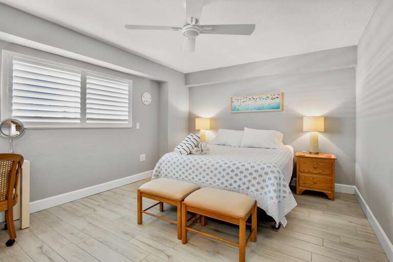 Drift off to sleep in your serene bedroom with coastal touches, warm bedside lighting, and gentle ceiling fan keeping you comfortable.