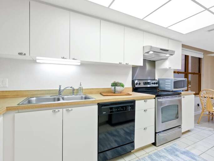 Bright modern kitchen with full appliances where you can prepare delicious meals under the beautiful skylight.