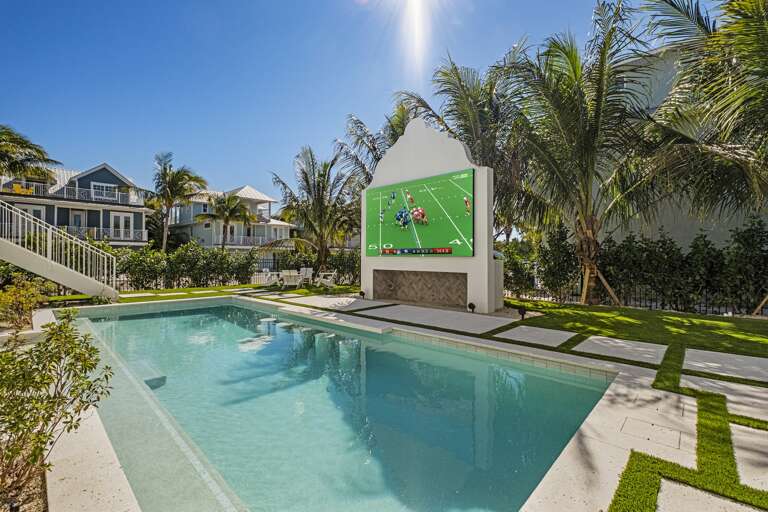 Private pool featuring an outdoor entertainment wall