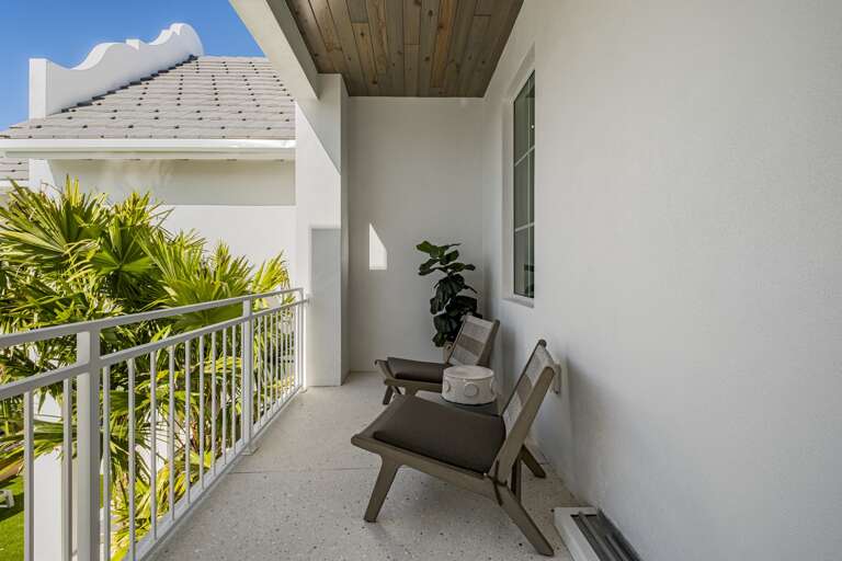 Private balcony with stylish seating and lush tropical views