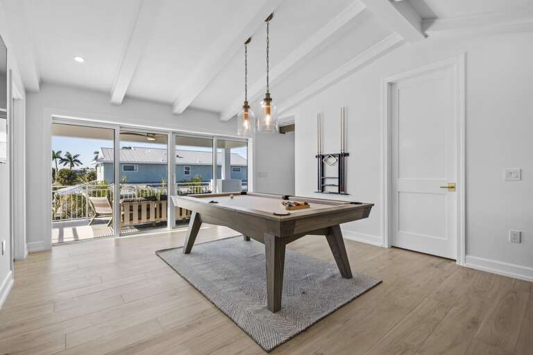 Indoor game room with pool table with tropical views