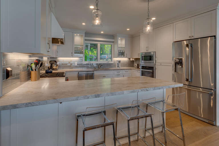 Spacious Kitchen With Stainless Steel Appliances And Marble Countertops