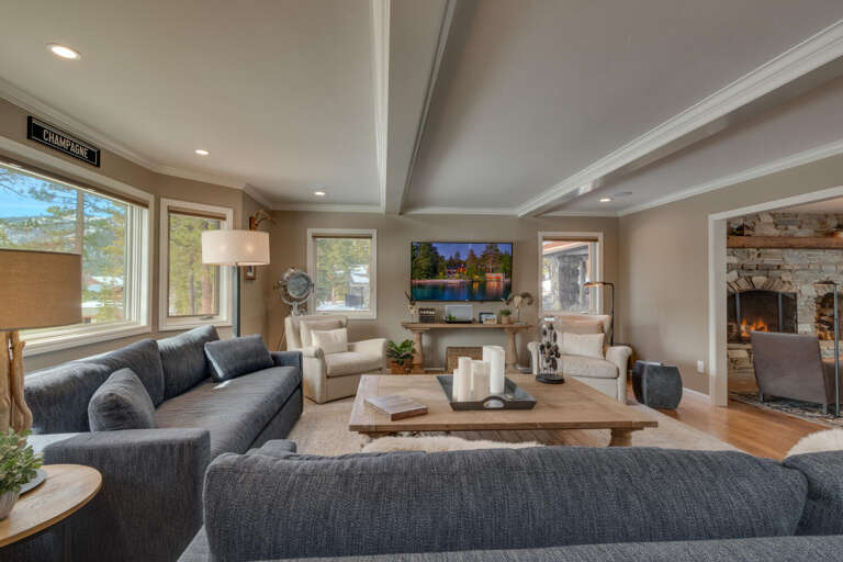 Spacious Living Area In Vacation Rental With Plush Sofas And A Stone Fireplace