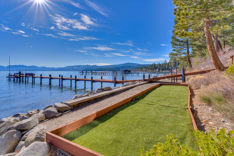 Sunny Lakeside Pier With Pine Pathway