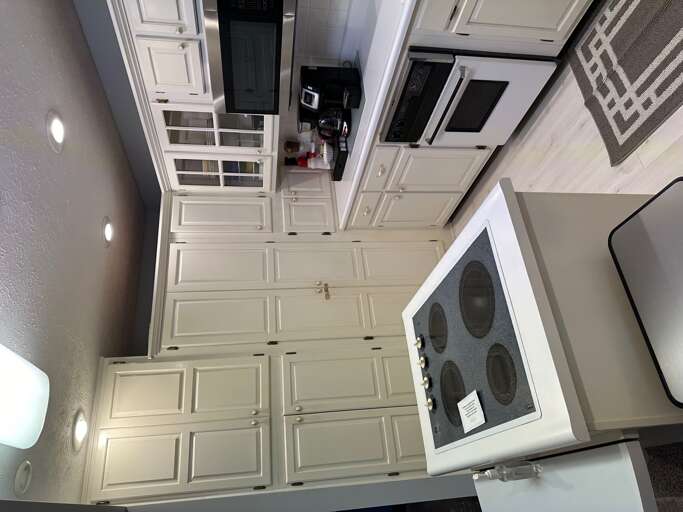 Kitchen  stove top , oven ,coffee pot , micorwave, plenty of dishes and new pots and pans .Two could eat at breakfast bar .