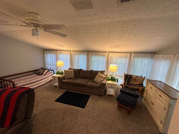 The back living room with another queen pull out sleeper sofa and day bed.