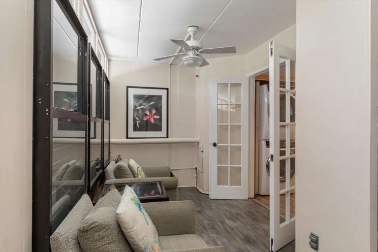 Front entry seating area with doors into kitchen/laundry area