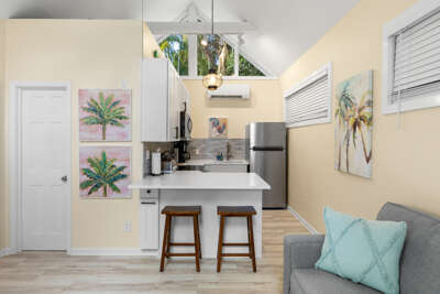 Your bright, airy retreat blends coastal charm with modern comfort—cathedral ceilings, sleek kitchen with breakfast bar, and a cozy living area perfect for unwinding after sun-soaked adventures.