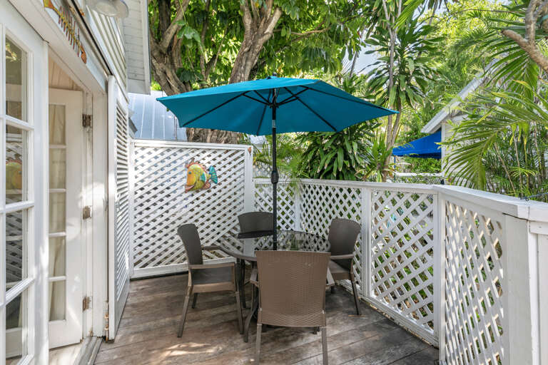 Your own private oasis awaits on this charming deck, where morning coffee or sunset cocktails feel like a mini escape beneath swaying palms and vibrant tropical greenery.
