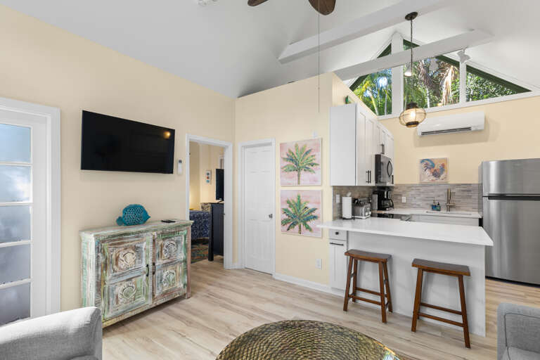 Bright, open-concept space where you can relax under vaulted ceilings and soak in tropical garden views through skylights above your fully-equipped kitchen.