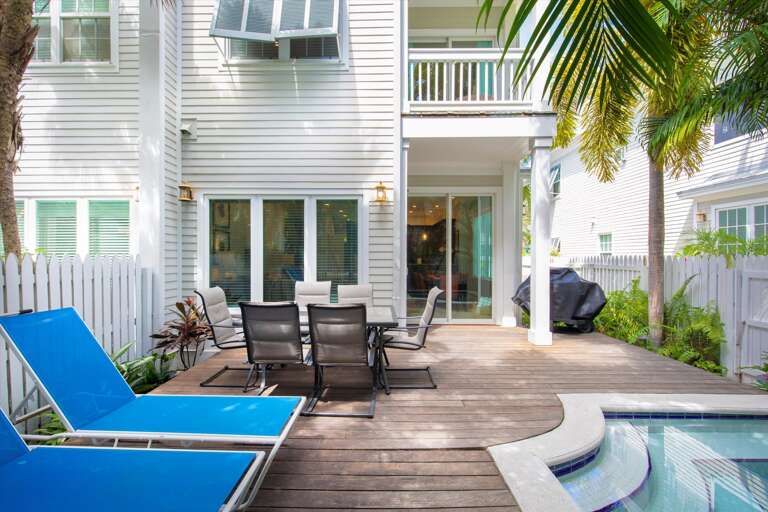 Pool deck with lounge chairs and outside dining area