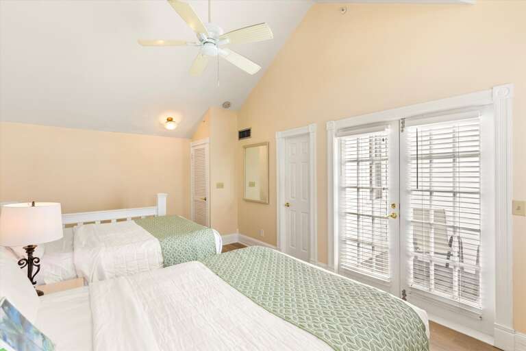 Primary loft style bedroom with balcony access