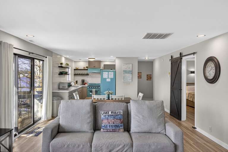 Bright, Breezy Living Space With A Sleek Sofa, Sliding Doors, And Integrated Kitchen