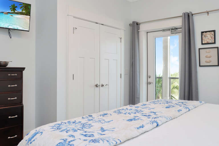 Bedroom 1 with TV and View onto Beachside Deck