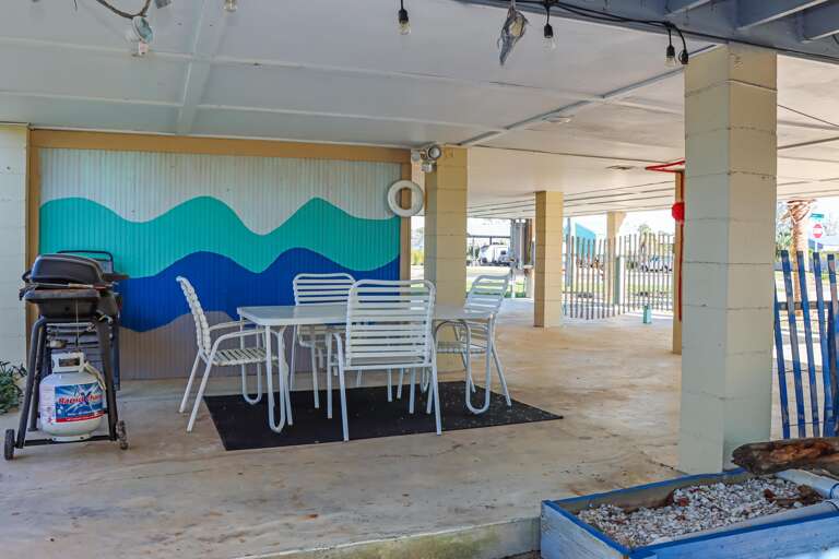 Outdoor Dining and Grilling Area Under House Outdoor Dining and Grilling Area Under House