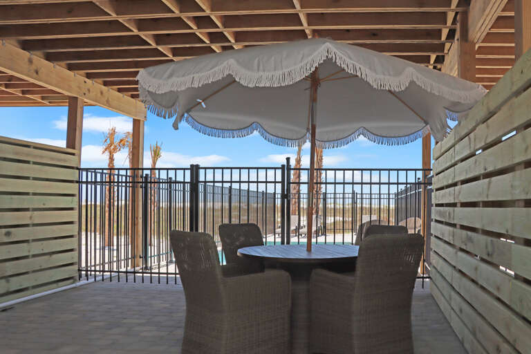 Outdoor Dining Under House with Pool View