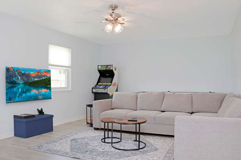 Living Room with TV and Arcade Games