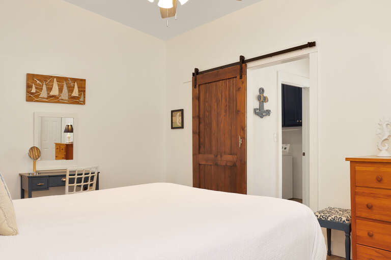 Bedroom 1 with View into Bedroom 2 and Laundry
