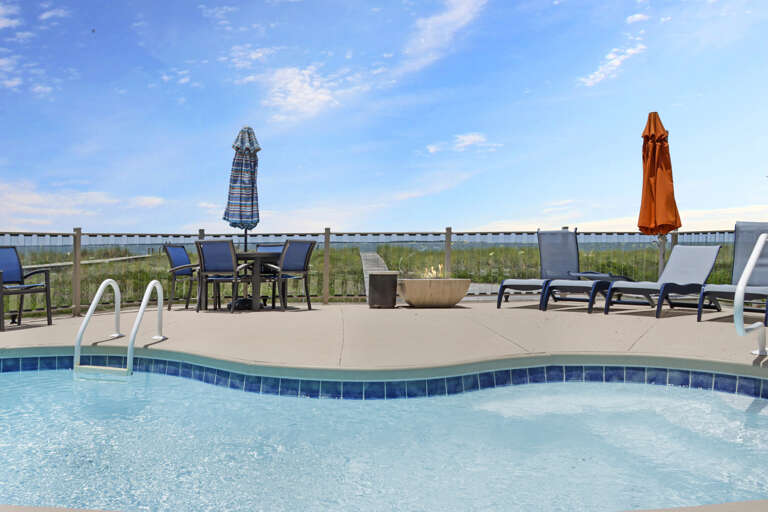 Beach Front Swimming Pool with Lots of Furniture
