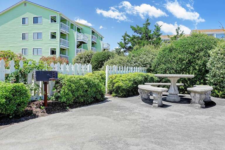 PICNIC AREA WITH CHARCOAL GRILL OUTSIDE POOL