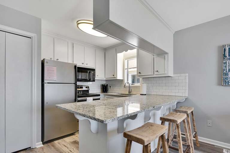 KITCHEN WITH BREAKFAST BAR WITH SEATING FOR 3
