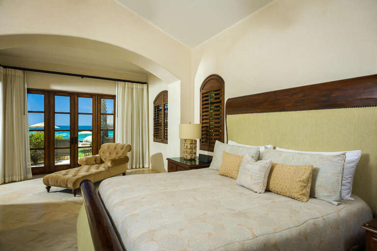 The rich, dark wood furnishings of the bedrooms contrasts with the pale walls, brightening up the room