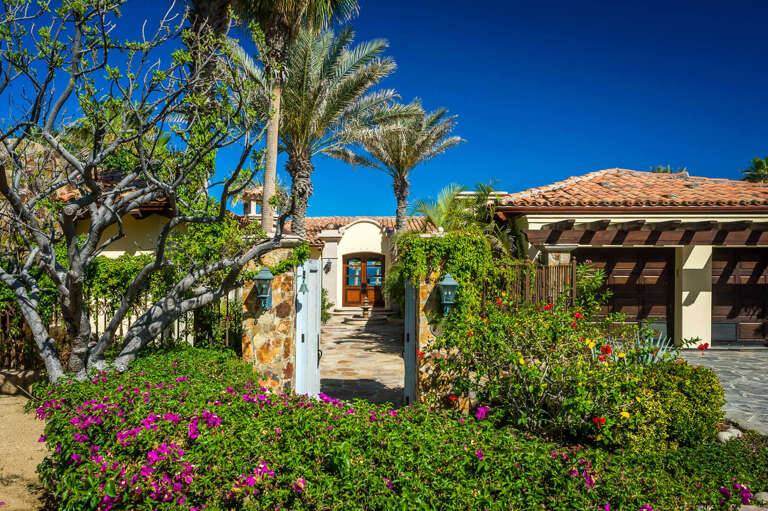 Appreciate the vibrant foliage and flowers of Villa Las Arenas 104 as soon as you pull up to the property