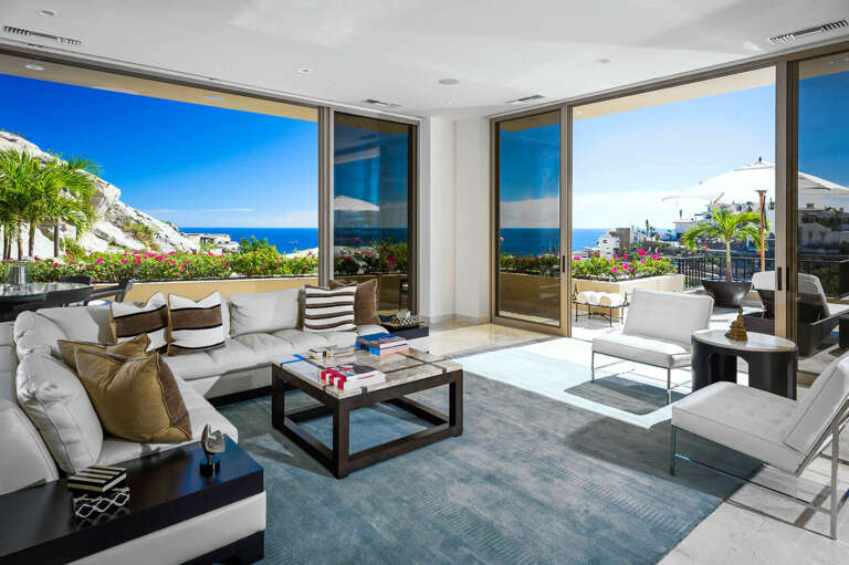 Floor-to-ceiling sliding glass doors are the only things that separate the open-concept living and dining area from the terrace