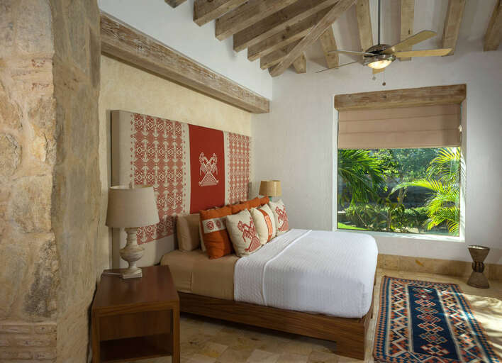 Vibrant linens and decor throughout the home represent the traditional Mexican folk art style of Piedra Blanca.