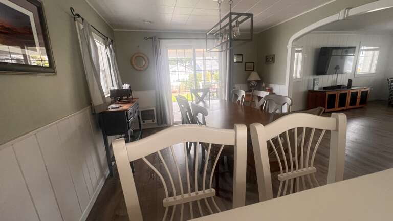 Gather around this inviting dining table where your group can share memorable meals together in this bright, welcoming space.