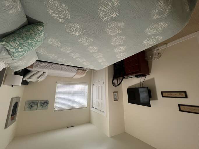Sink into crisp, comfortable bedding and wake refreshed in your bright, thoughtfully appointed bedroom with coastal accents, entertainment, and natural light.