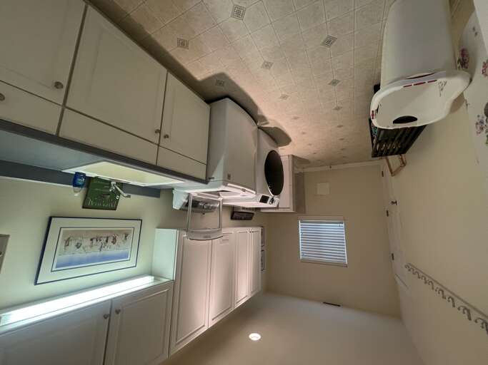 Your private kitchen awaits with full appliances, ample counter space, and bright natural light streaming through the window—perfect for preparing your favorite meals during your stay.