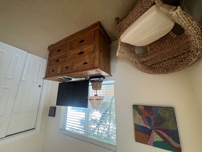 Bright natural light fills your room, where rustic wood furnishings meet coastal charm. Enjoy modern entertainment and eclectic art that adds character to your peaceful retreat.