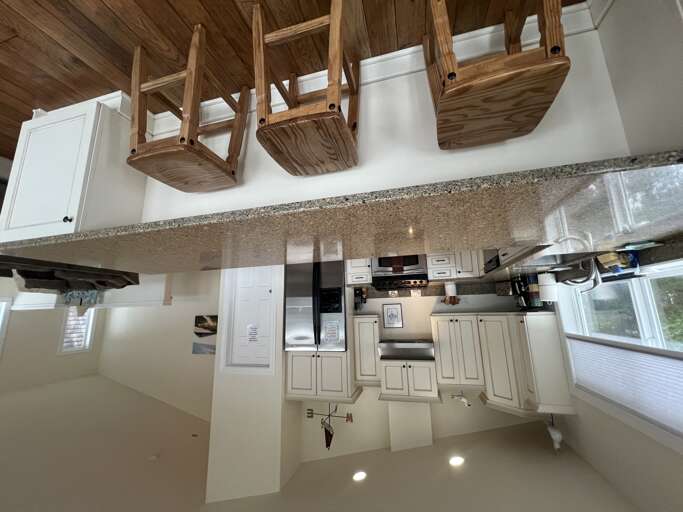 Your fully-equipped kitchen features gleaming granite countertops, modern appliances, and charming wooden accentsâperfect for preparing meals in a bright, welcoming space.
