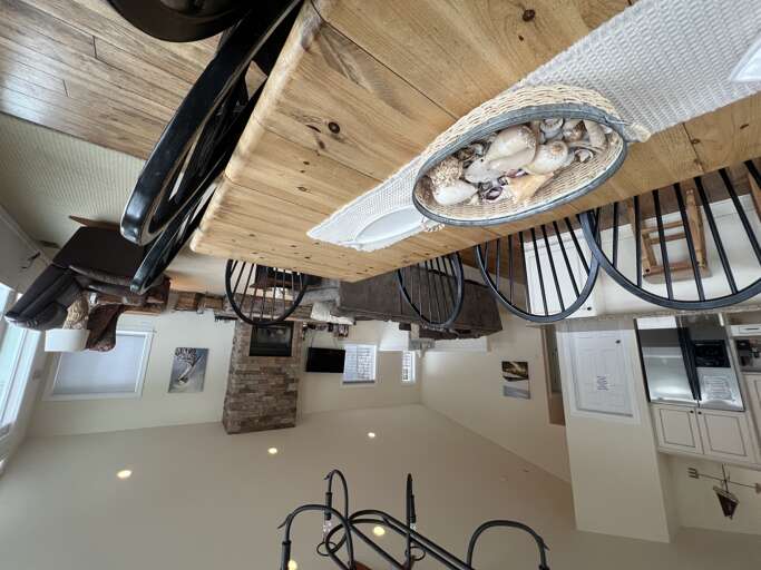 Rustic wood beams and unique nautical touches create a cozy, inviting space where you'll gather for meals and make memories around the table.