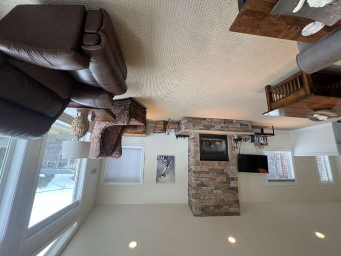 Sink into plush leather seating by the stone fireplace, where rustic charm meets modern comfortâyour perfect retreat for cozy evenings and warm conversations.